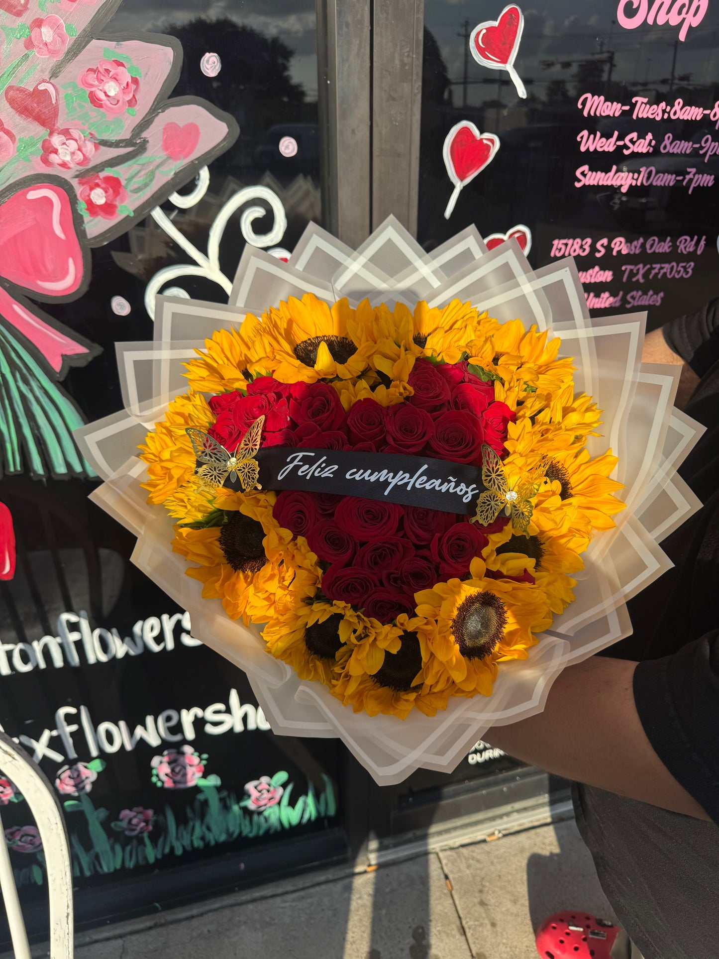 24 red roses + sunflowers around